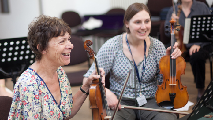 undefinedtwo violinists laughing